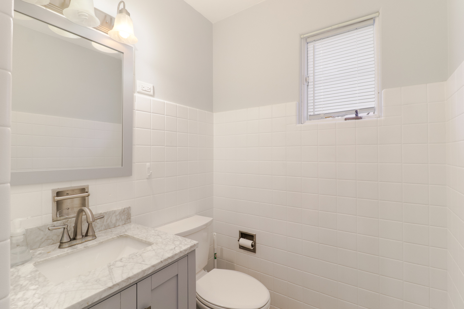 900 Beech Street Normal, IL 61761 - Photo 36 of 36 a bathroom with a granite countertop toilet sink and mirror