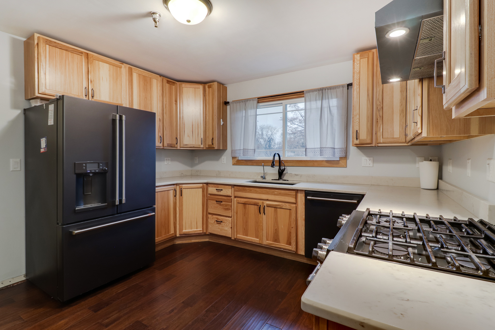 900 Beech Street Normal, IL 61761 - Photo 5 of 36 a kitchen with granite countertop stainless steel appliances a refrigerator cabinets and wooden floor