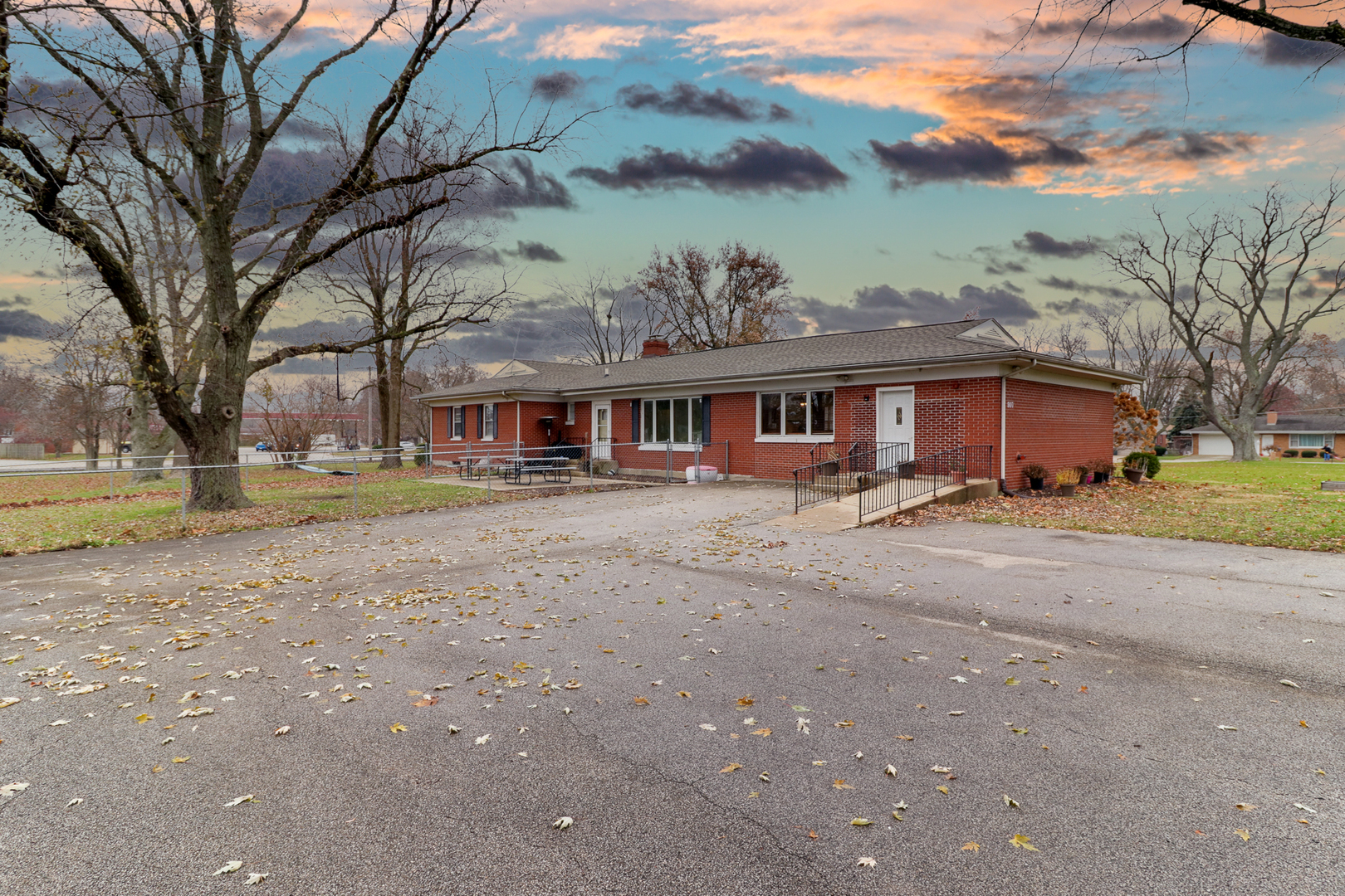 900 Beech Street Normal, IL 61761 - Photo 6 of 36 a front view of a building with a garden and trees