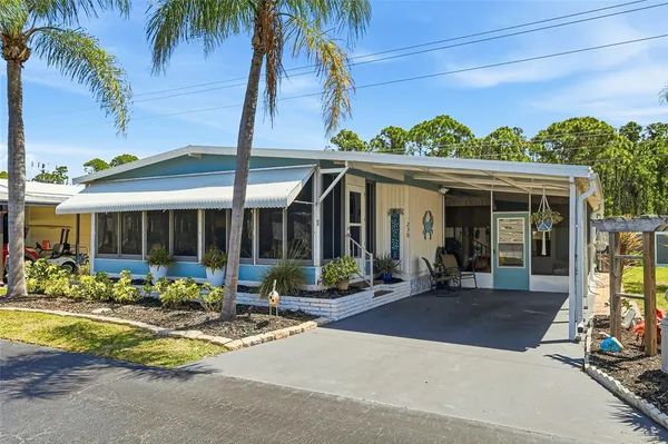 a view of a house with sitting area and garden