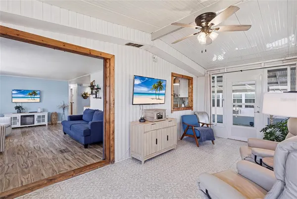 a living room with furniture chandelier and a window