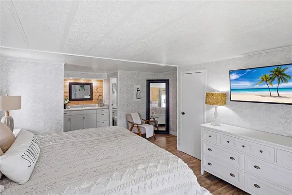 a bedroom with a bed and a television