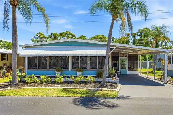 front view of a building with a garden and swimming pool