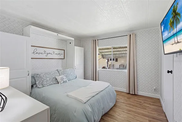 a bedroom with a large bed and a window