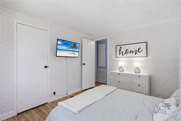 a bedroom with a bed and cabinets