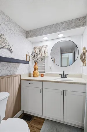 a bathroom with a toilet a sink and a mirror