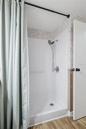 a bathroom with a glass shower door