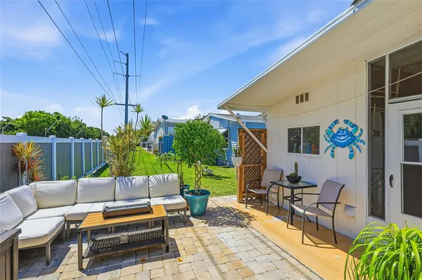 a backyard of a house with outdoor seating