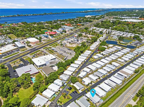an aerial view of a city with lots of residential buildings and ocean view