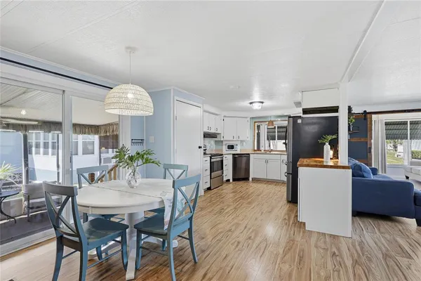 a view of a dining room with furniture and wooden floor