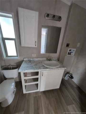 a living room with a table chairs and a window