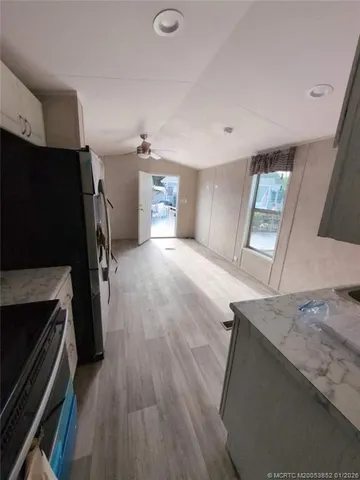 a view of a kitchen cabinets and a stove top oven