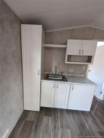 a kitchen with stainless steel appliances a sink and a refrigerator