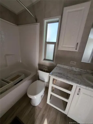 a bathroom with a toilet and a mirror