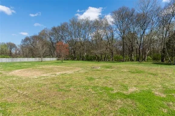a view of outdoor space with a garden and trees