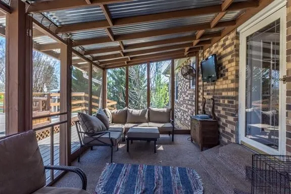a living room with furniture and a floor to ceiling window