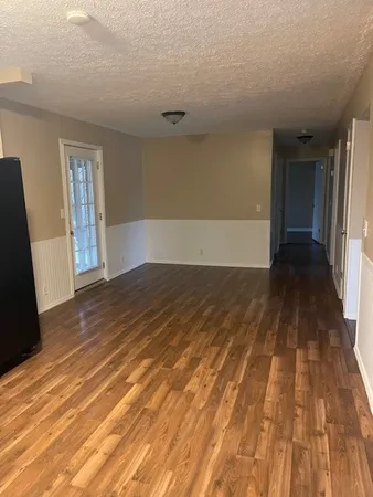 a view of a room with wooden floor and stairs