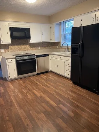 a kitchen with stainless steel appliances a stove a sink and a refrigerator