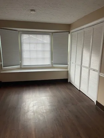 a view of room with window and hardwood floor