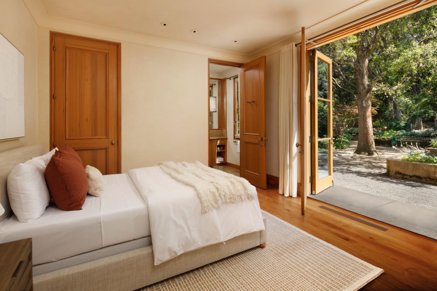 211 Winding Way Woodside, CA 94062 - Photo 14 of 32 a bedroom with a bed lamp and a large window