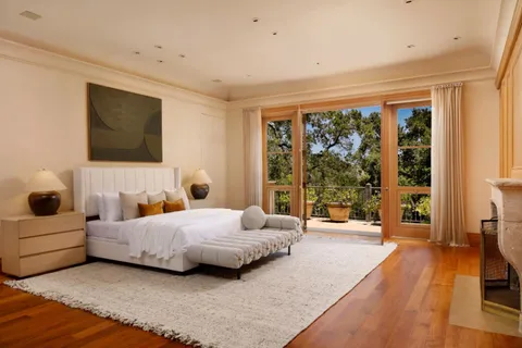 a large white room with a large window and pool table