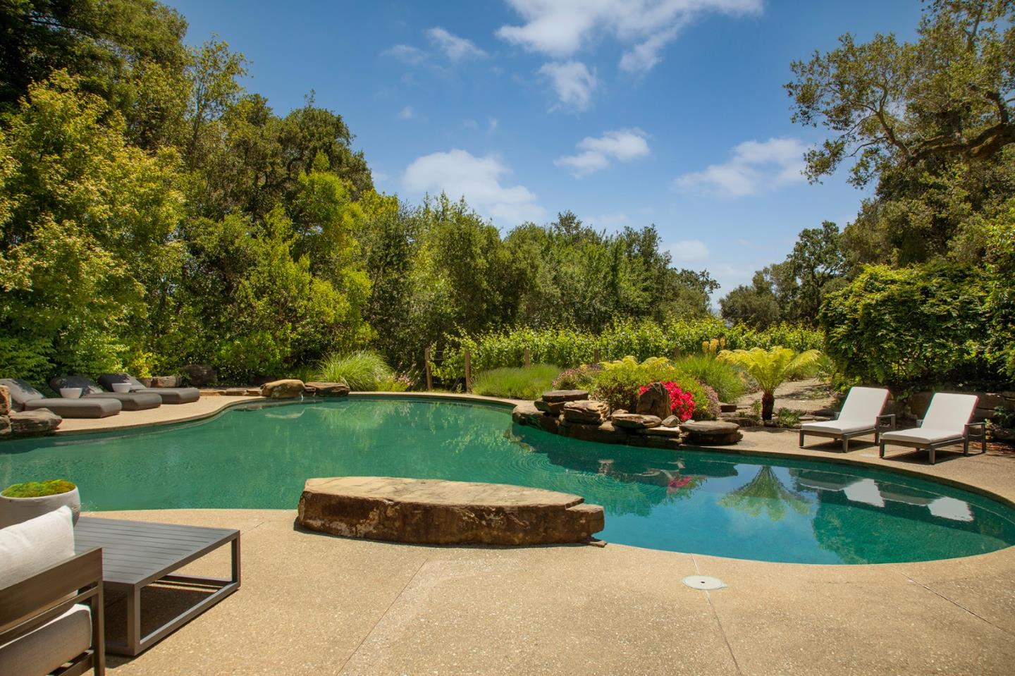 211 Winding Way Woodside, CA 94062 - Photo 29 of 32 a view of a swimming pool and lounge chairs in back of the house