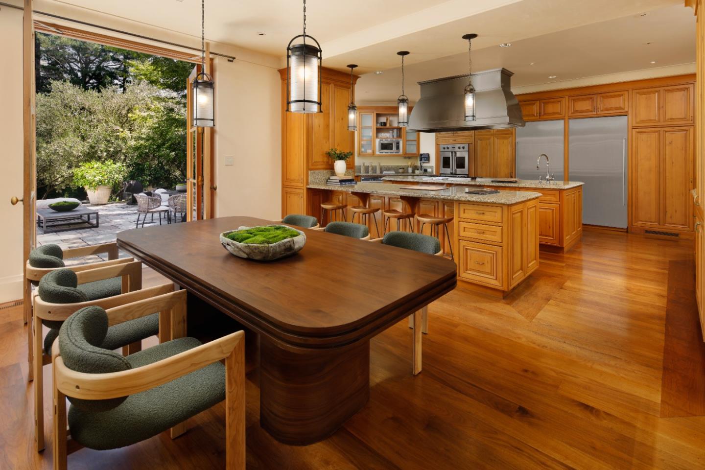 211 Winding Way Woodside, CA 94062 - Photo 10 of 32 a kitchen with stainless steel appliances kitchen island granite countertop a table chairs sink and cabinets