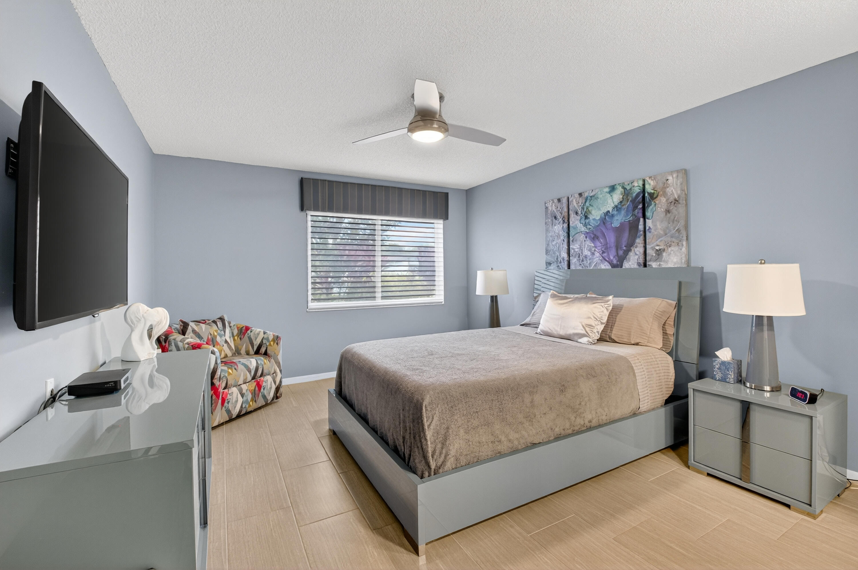 8136 Whispering Palm Drive, Unit B Boca Raton, FL 33496 - Photo 16 of 37 a bedroom with a bed and a flat screen tv