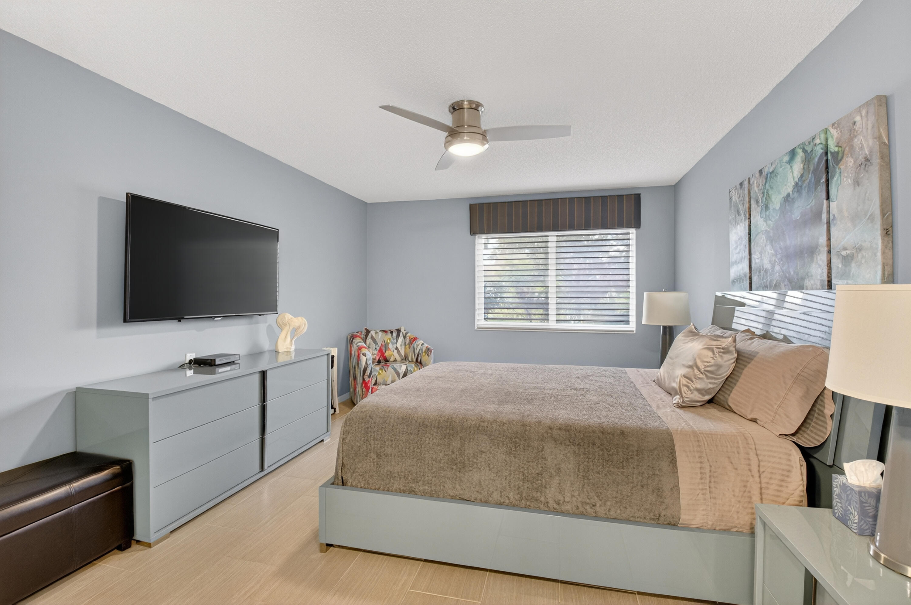 8136 Whispering Palm Drive, Unit B Boca Raton, FL 33496 - Photo 17 of 37 a bedroom with a bed and a flat screen tv