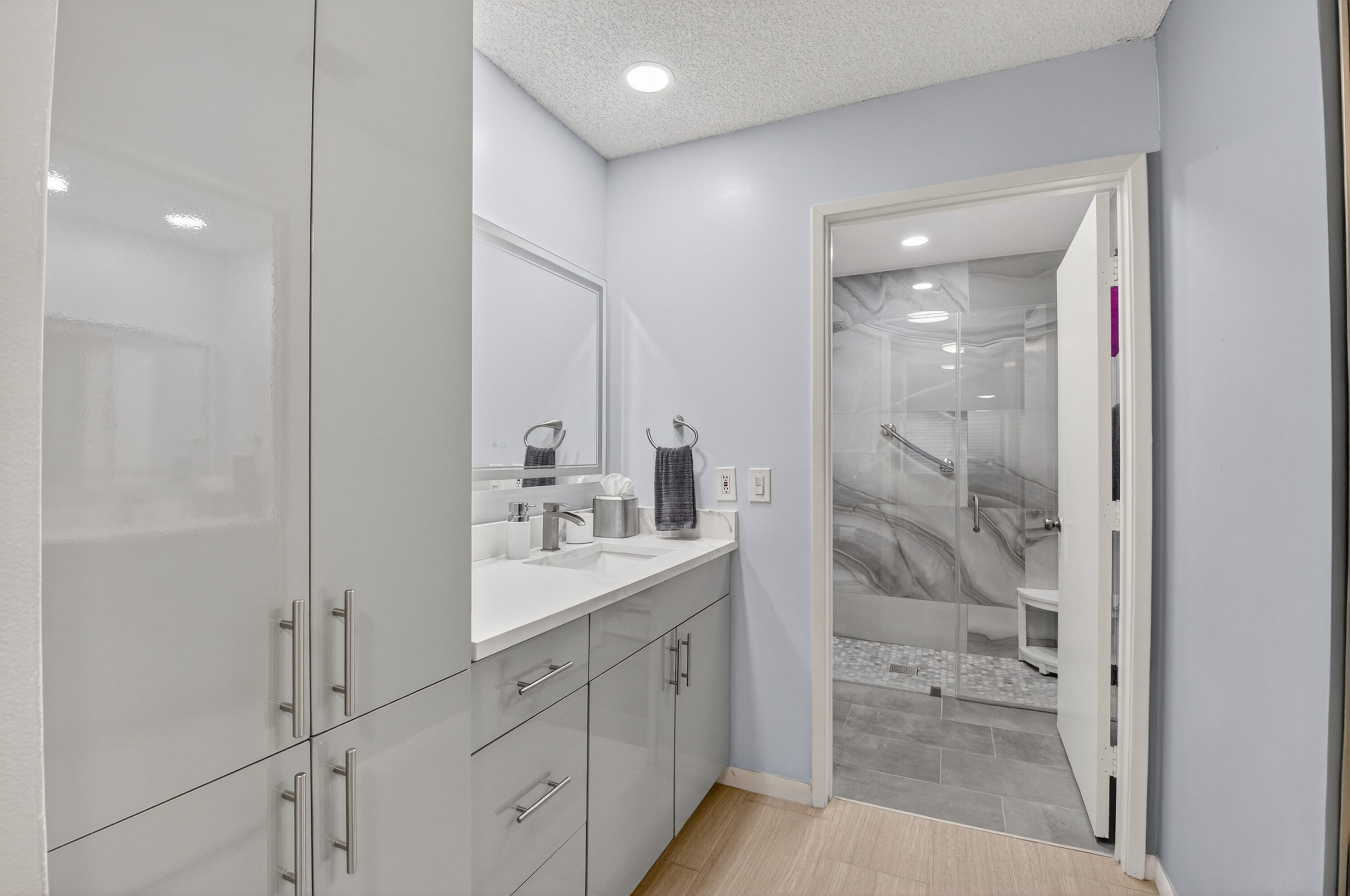 8136 Whispering Palm Drive, Unit B Boca Raton, FL 33496 - Photo 19 of 37 a bathroom with a granite countertop sink mirror and shower