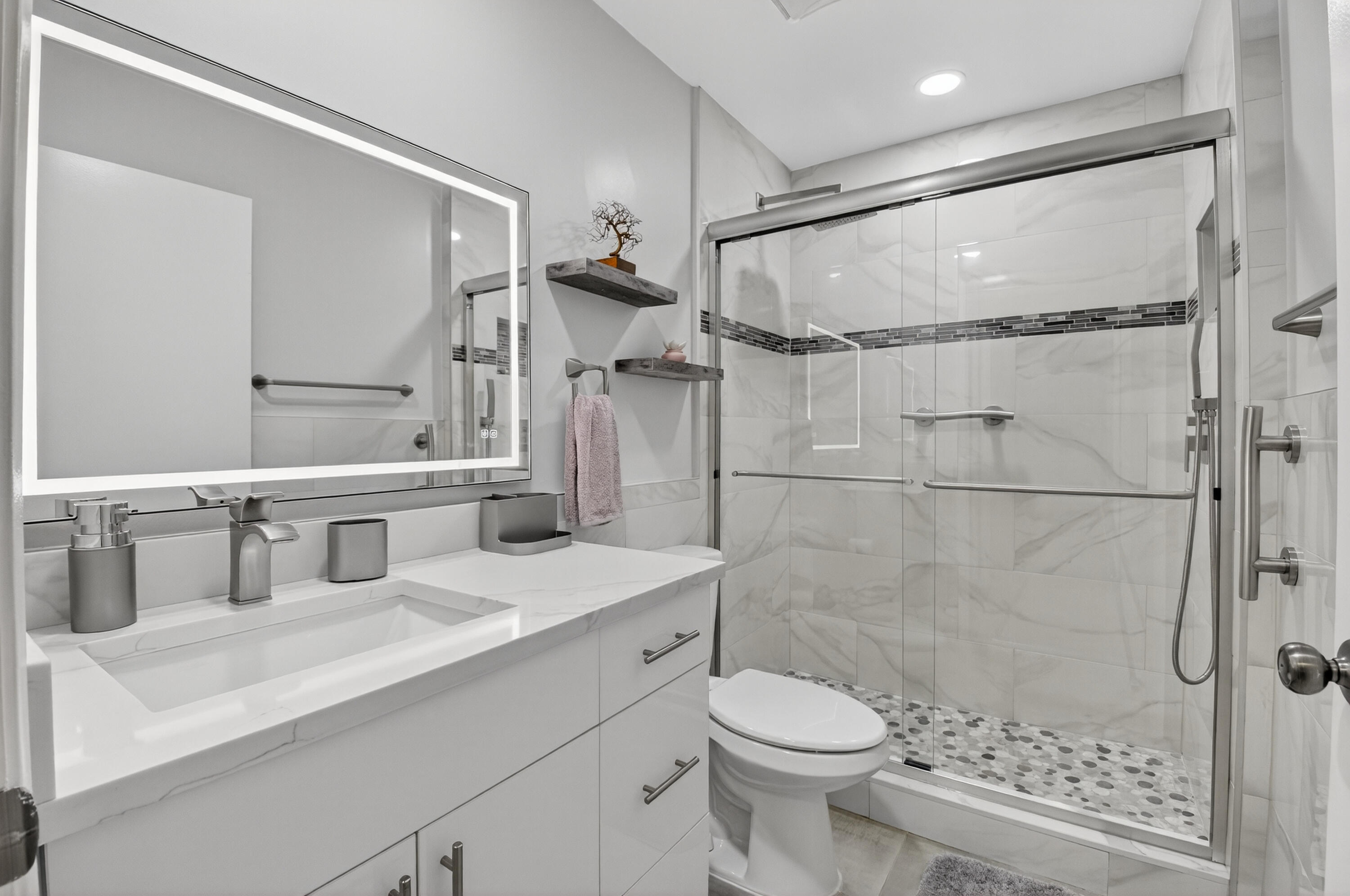 8136 Whispering Palm Drive, Unit B Boca Raton, FL 33496 - Photo 22 of 37 a bathroom with a sink toilet a mirror and shower