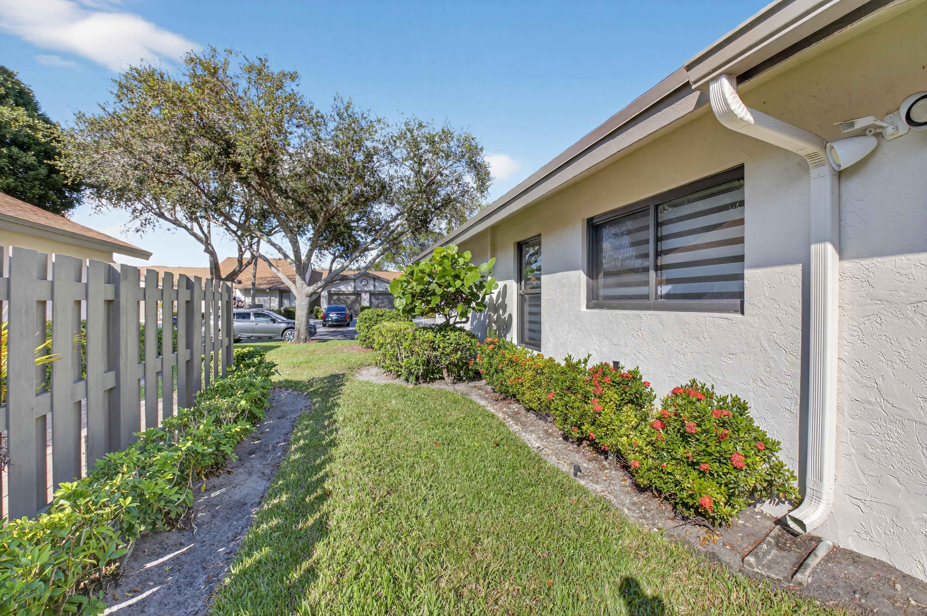 8136 Whispering Palm Drive, Unit B Boca Raton, FL 33496 - Photo 27 of 37 a front view of a house with a yard