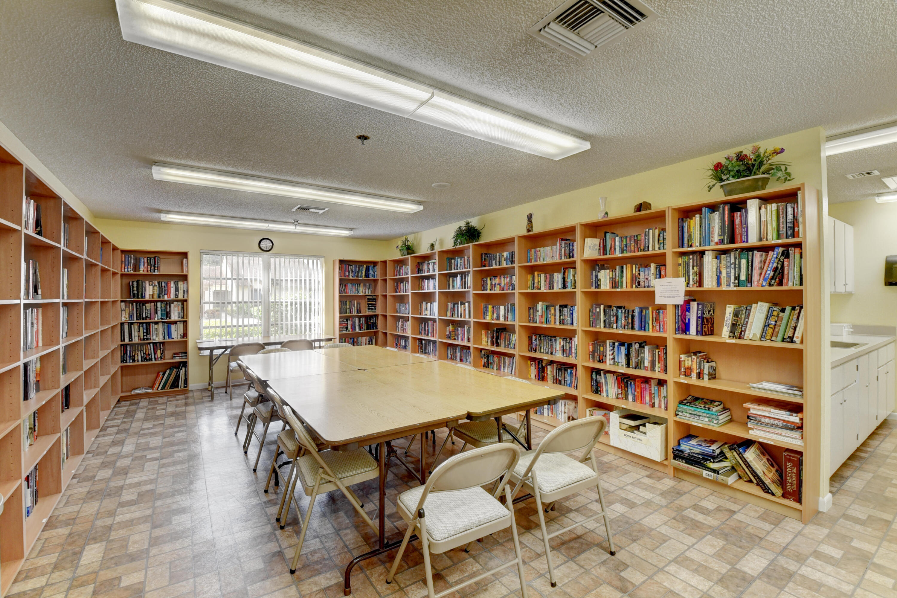 8136 Whispering Palm Drive, Unit B Boca Raton, FL 33496 - Photo 34 of 37 a room with furniture a rug and a book shelf