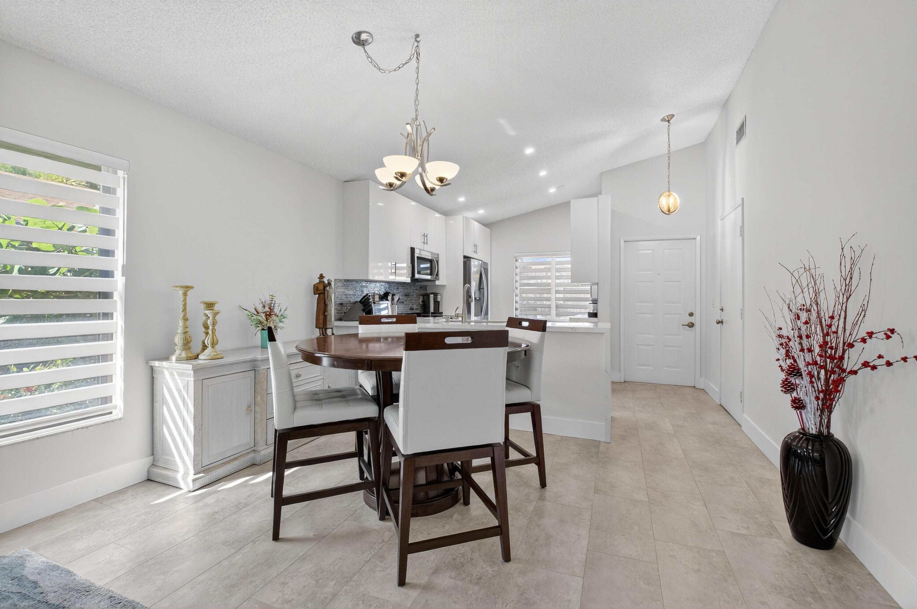 8136 Whispering Palm Drive, Unit B Boca Raton, FL 33496 - Photo 4 of 37 a view of a dining room with furniture and a chandelier