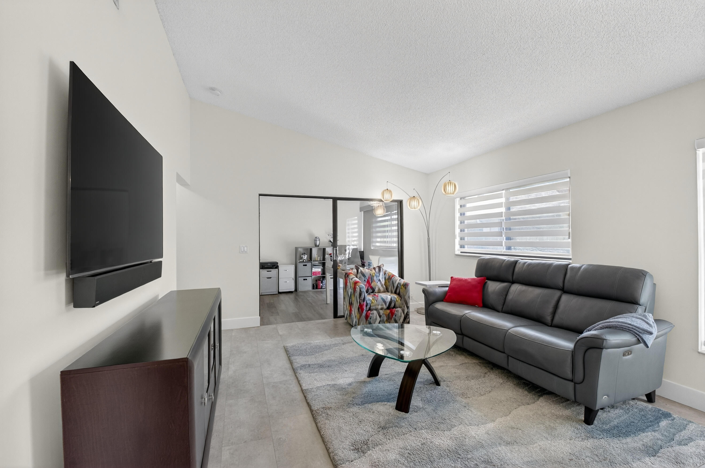 8136 Whispering Palm Drive, Unit B Boca Raton, FL 33496 - Photo 7 of 37 a living room with furniture and a flat screen tv