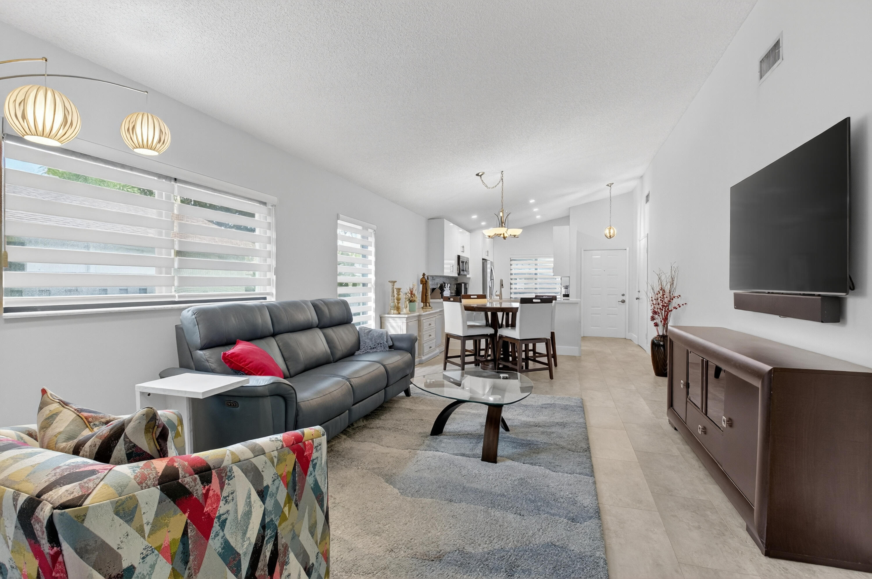 8136 Whispering Palm Drive, Unit B Boca Raton, FL 33496 - Photo 9 of 37 a living room with furniture and a flat screen tv