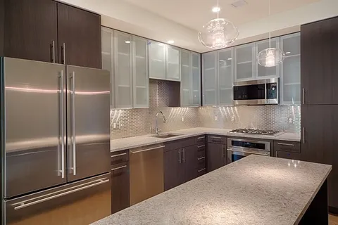 a kitchen with a refrigerator and a sink