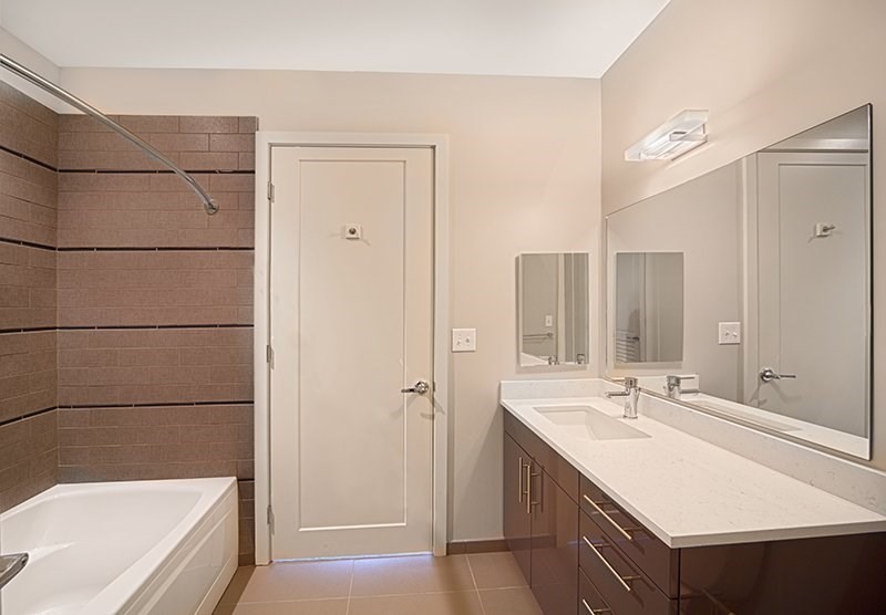 1 Canal Street, Unit 1109 Boston, MA 02114 - Photo 5 of 12 a bathroom with a tub sink shower and mirror