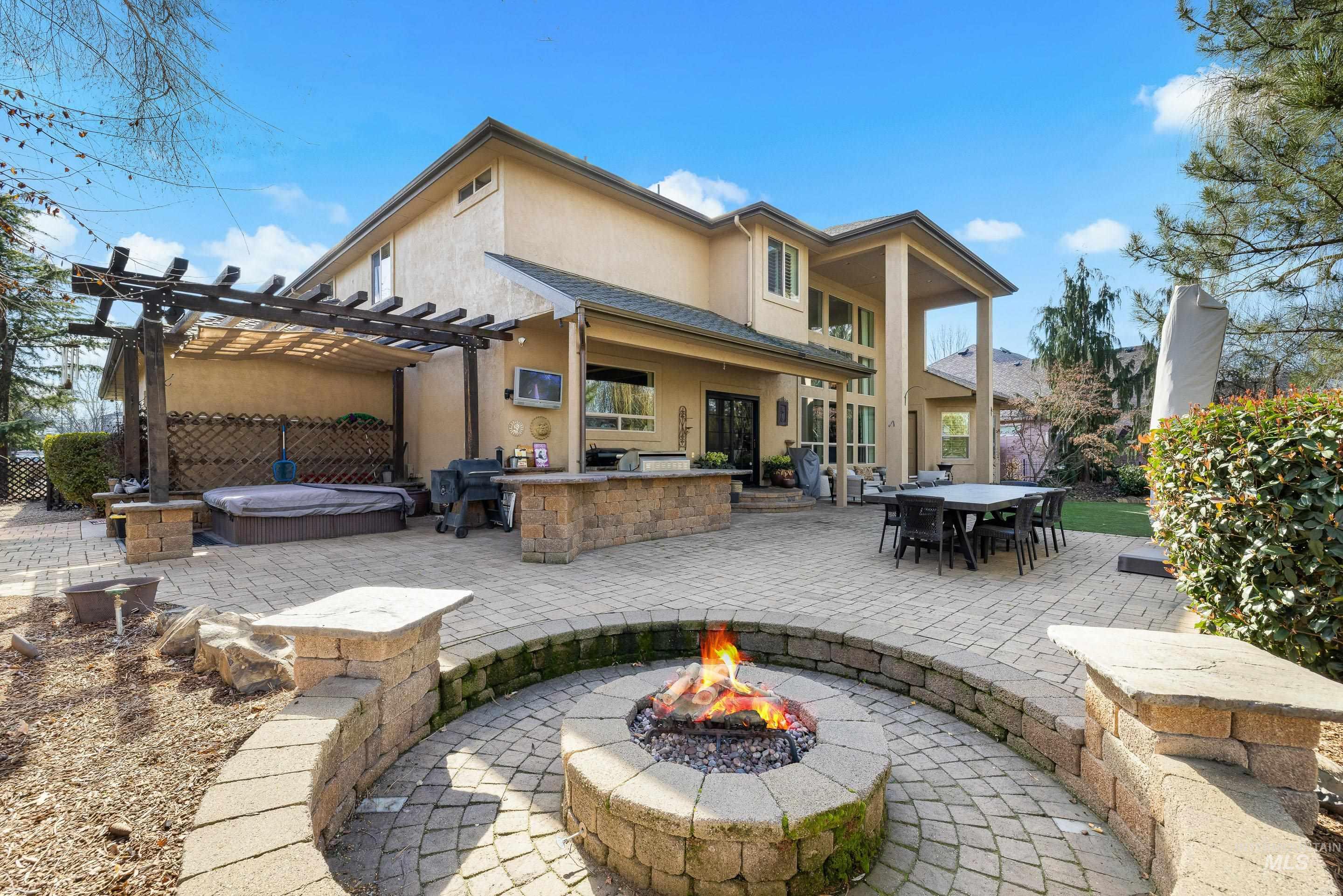 1166 East Rivers End Drive Eagle, ID 83616 - Photo 46 of 50 Back of house with a patio, stucco siding, a pergola, an outdoor fire pit, and an outdoor kitchen / dining area