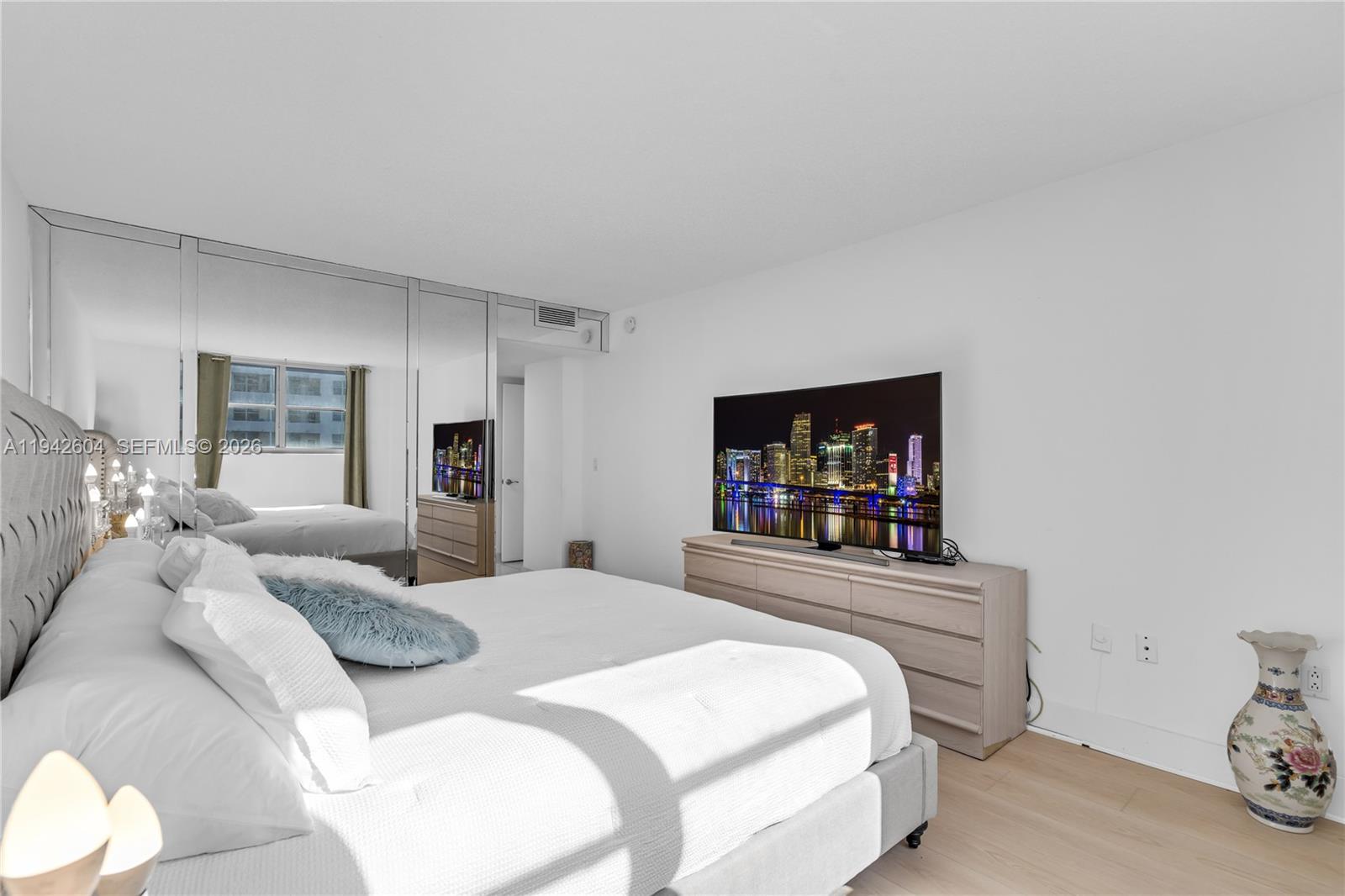 9273 Collins Avenue, Unit 503 Surfside, FL 33154 - Photo 21 of 48 a bedroom with a bed and a flat screen tv