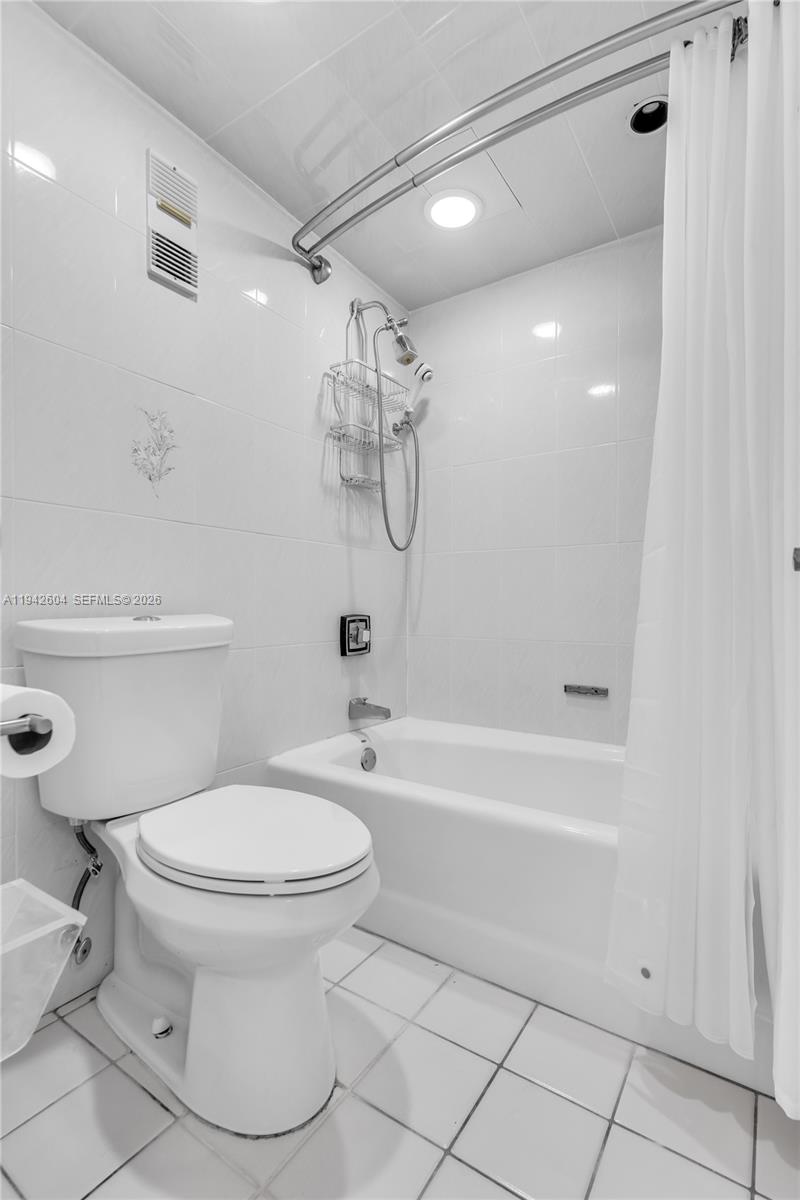 9273 Collins Avenue, Unit 503 Surfside, FL 33154 - Photo 23 of 48 a bathroom with a toilet and a bathtub