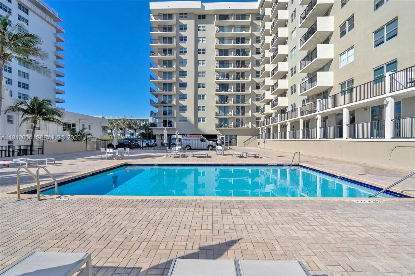 9273 Collins Avenue, Unit 503 Surfside, FL 33154 - Photo 29 of 48 a swimming pool with outdoor seating
