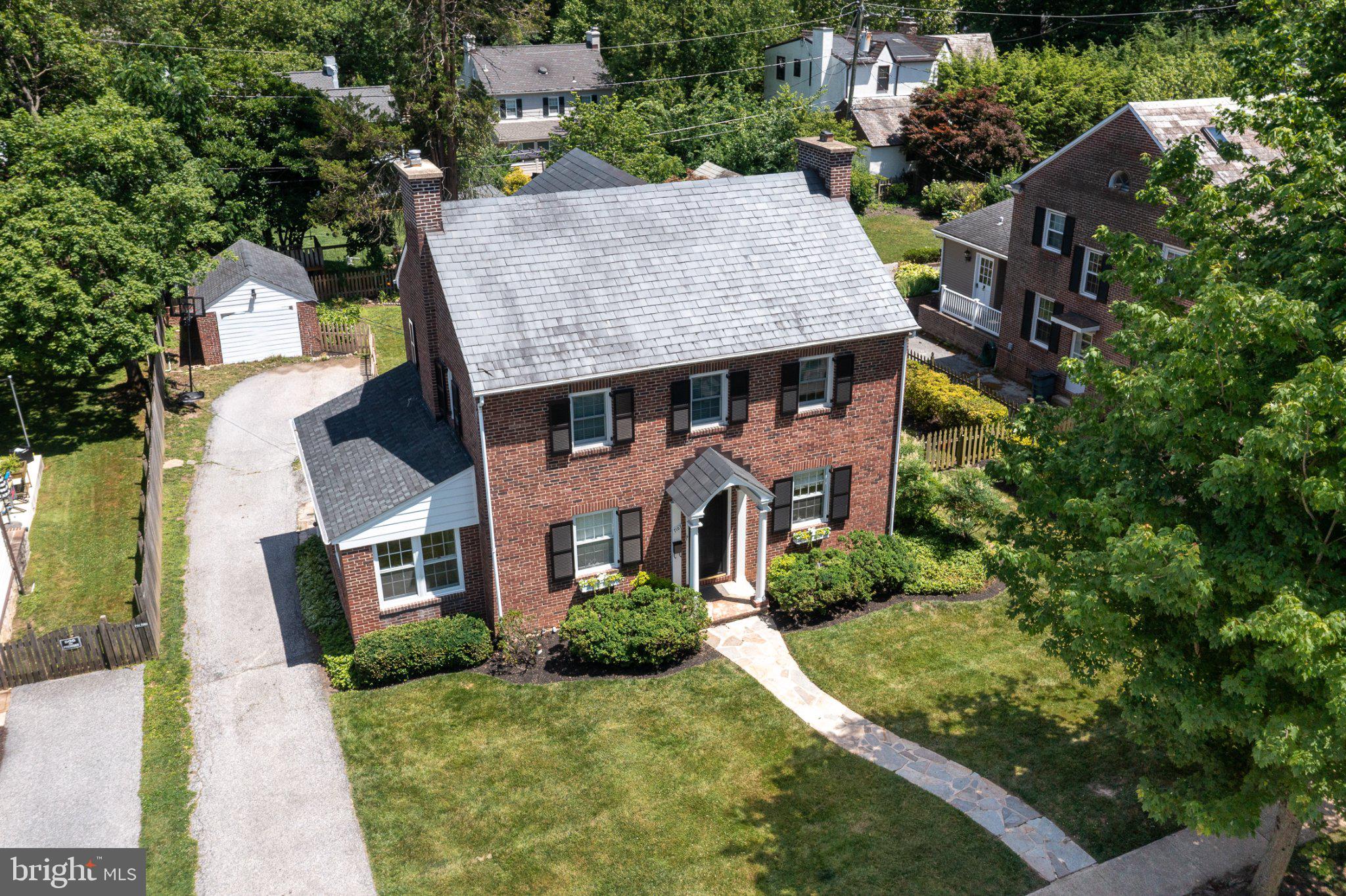 Charming brick home in lush surroundings.