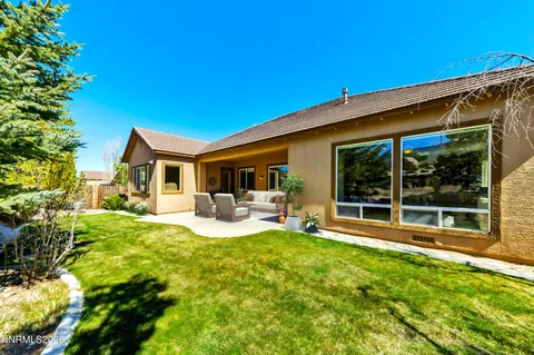 a view of a house with backyard porch and sitting area
