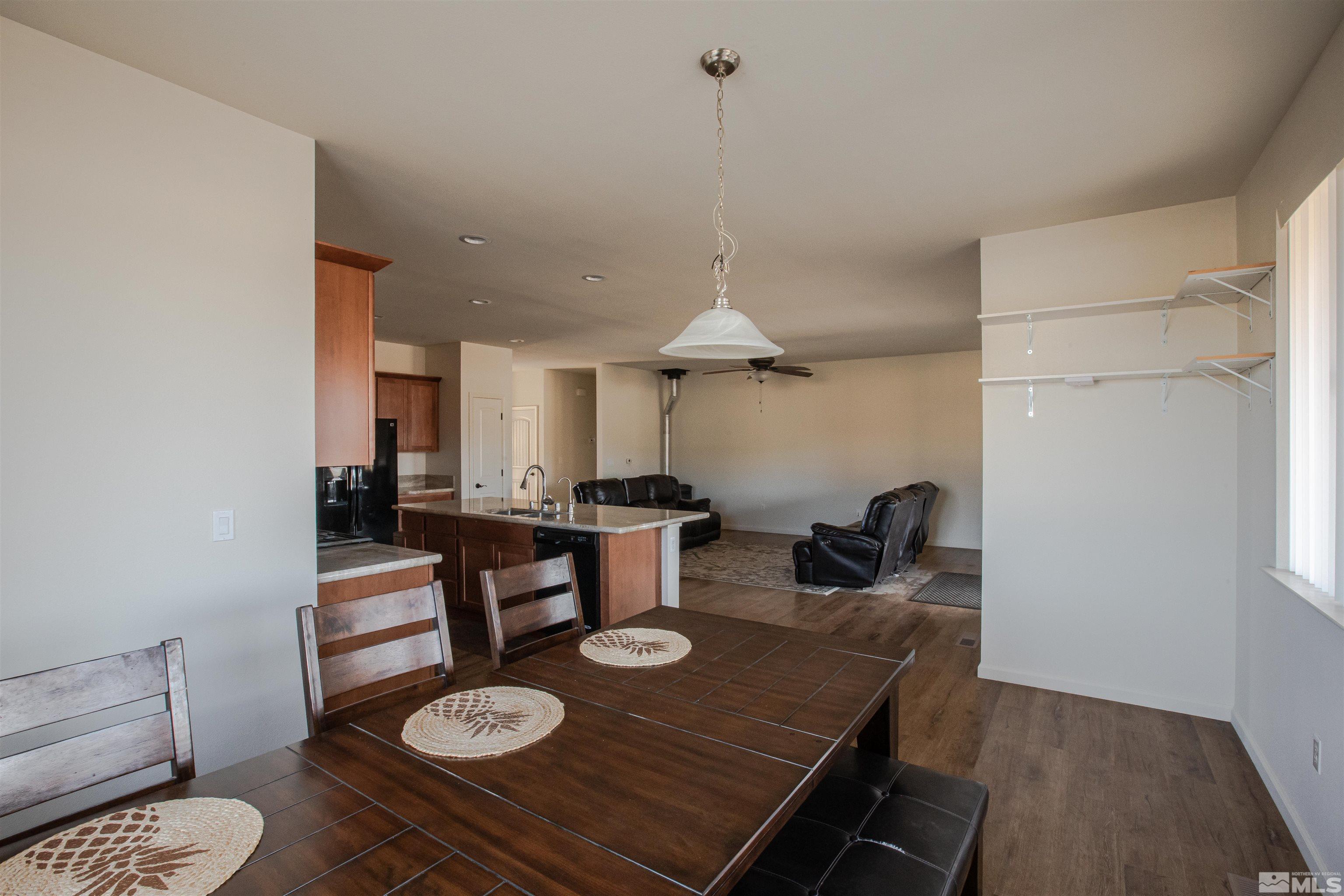 100 Wrangler Ranch Court Reno, NV 89510 - Photo 11 of 35 a kitchen with a table and chairs in it