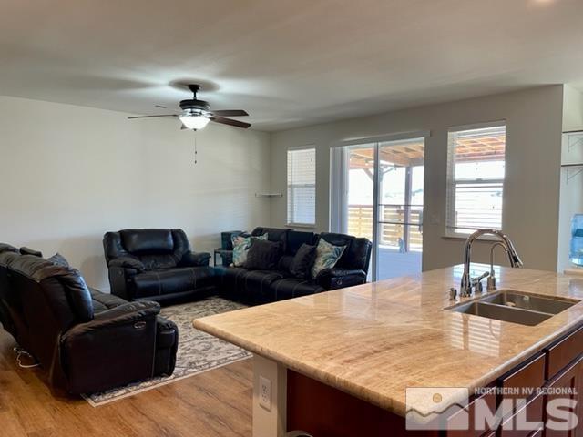 100 Wrangler Ranch Court Reno, NV 89510 - Photo 5 of 35 a living room with furniture a two couches and a dining table with wooden floor