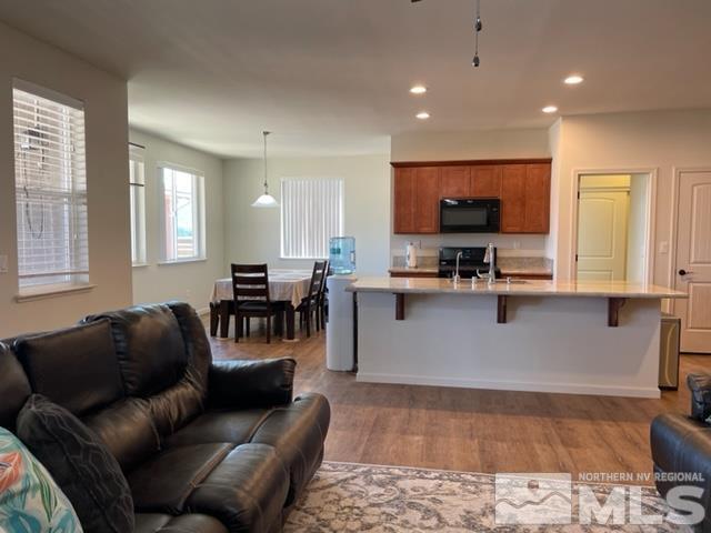 100 Wrangler Ranch Court Reno, NV 89510 - Photo 6 of 35 a living room with furniture and a flat screen tv