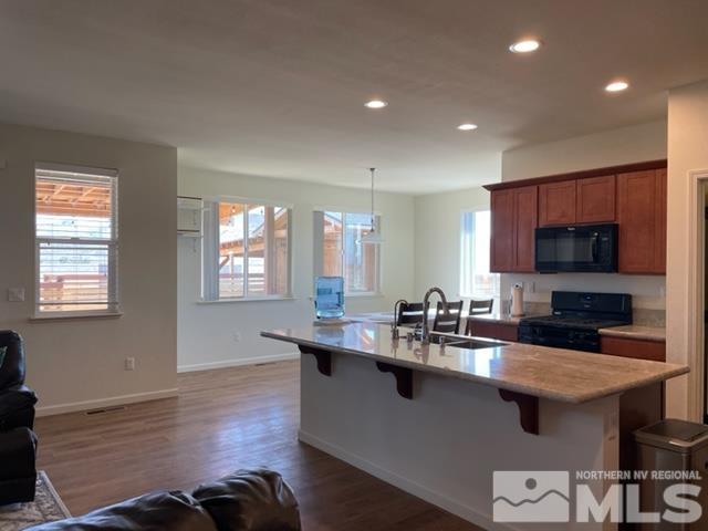 100 Wrangler Ranch Court Reno, NV 89510 - Photo 8 of 35 a kitchen with stainless steel appliances granite countertop a sink a stove and a wooden floors
