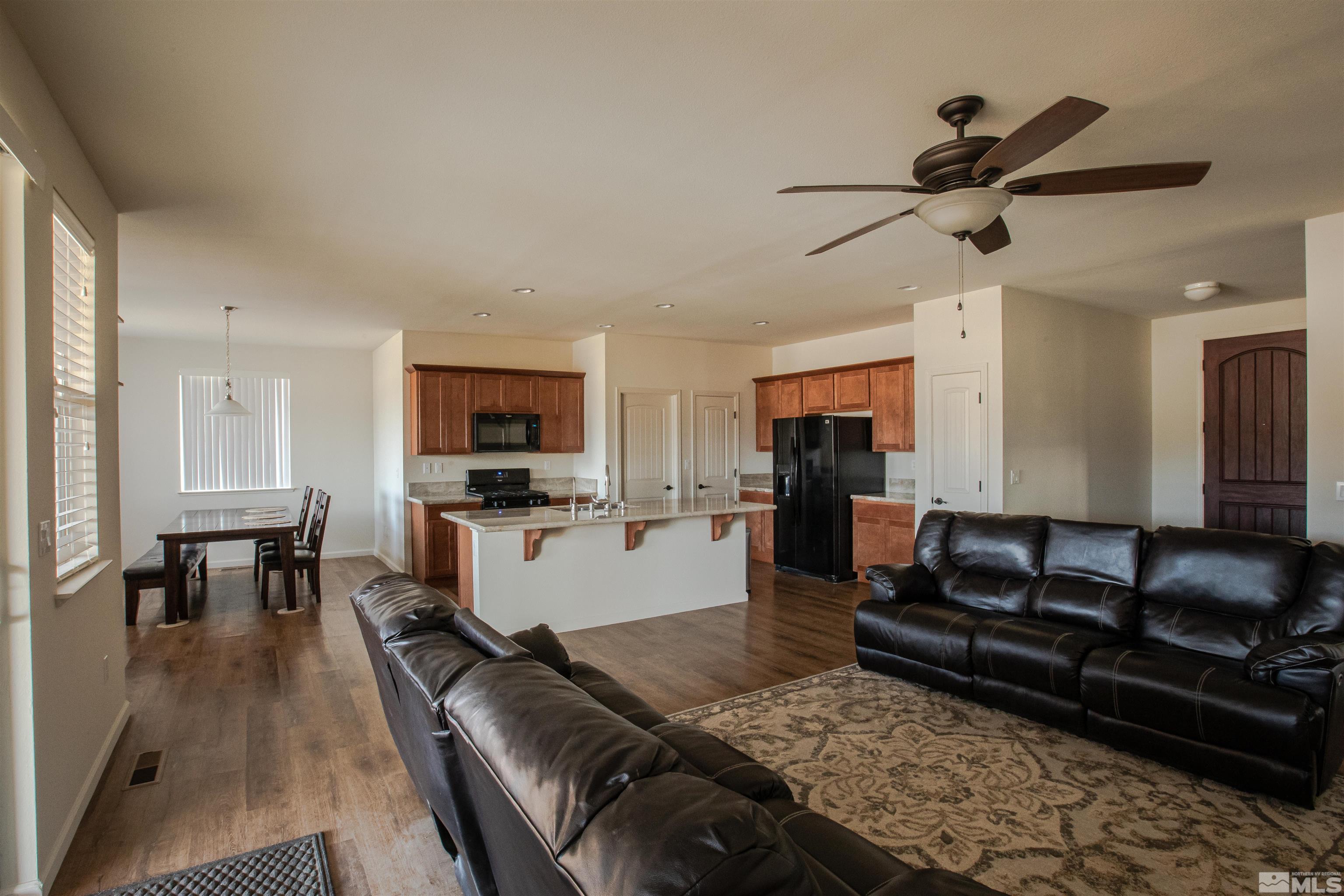 100 Wrangler Ranch Court Reno, NV 89510 - Photo 10 of 35 a living room with furniture and a flat screen tv