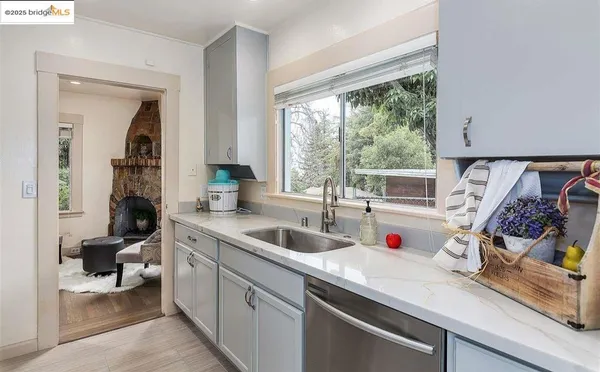 a kitchen with sink refrigerator and window
